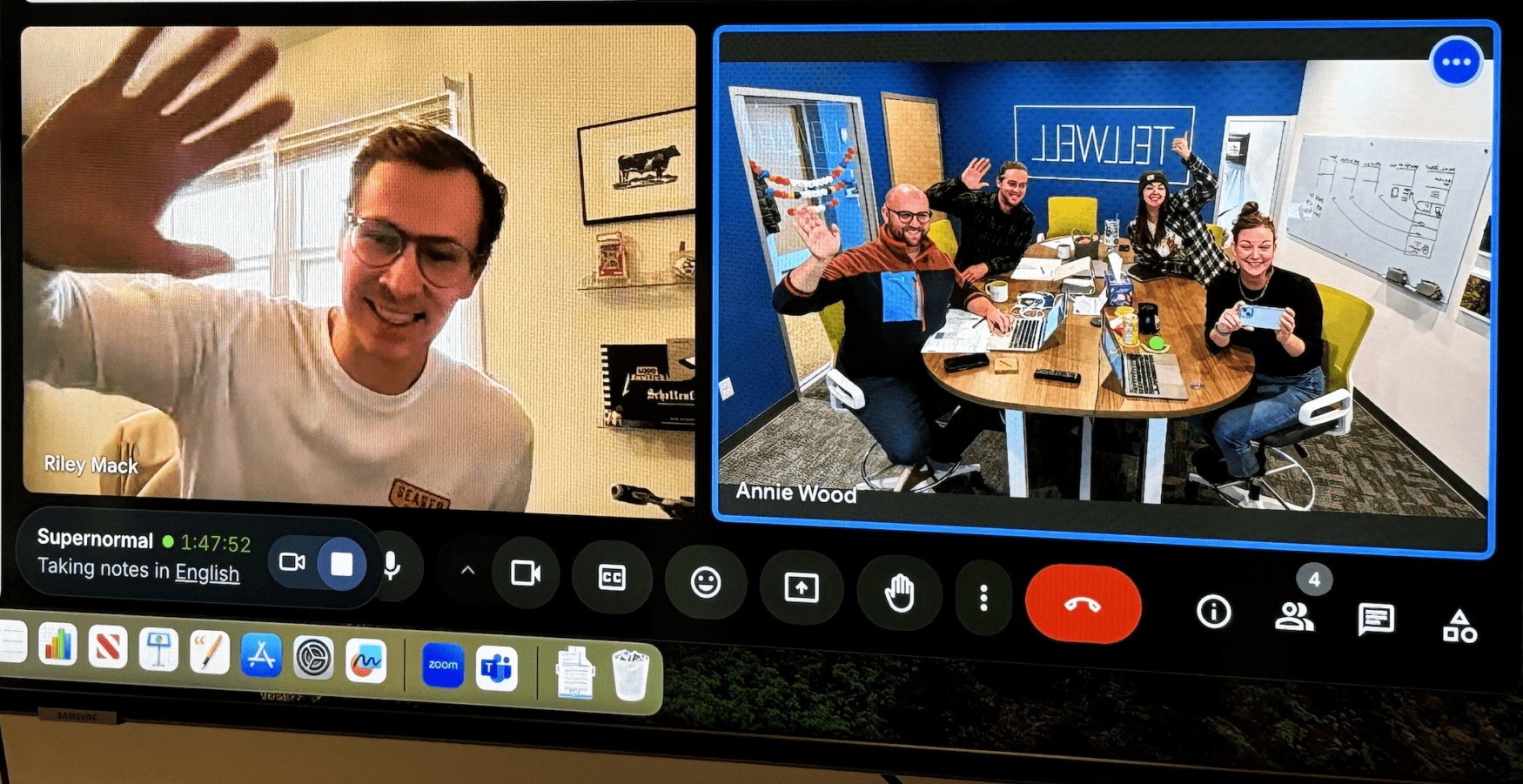 Screenshot of a virtual meeting on a video call platform. On the left side, Riley Mack waves to the camera from a well-lit room with a cow picture on the wall behind him. On the right, four people in an office labeled "Tellwell" also wave and smile, seated around a table with laptops, coffee mugs, and notebooks. The group looks friendly and engaged. The interface shows active call tools, including a green dot indicating recording in progress.